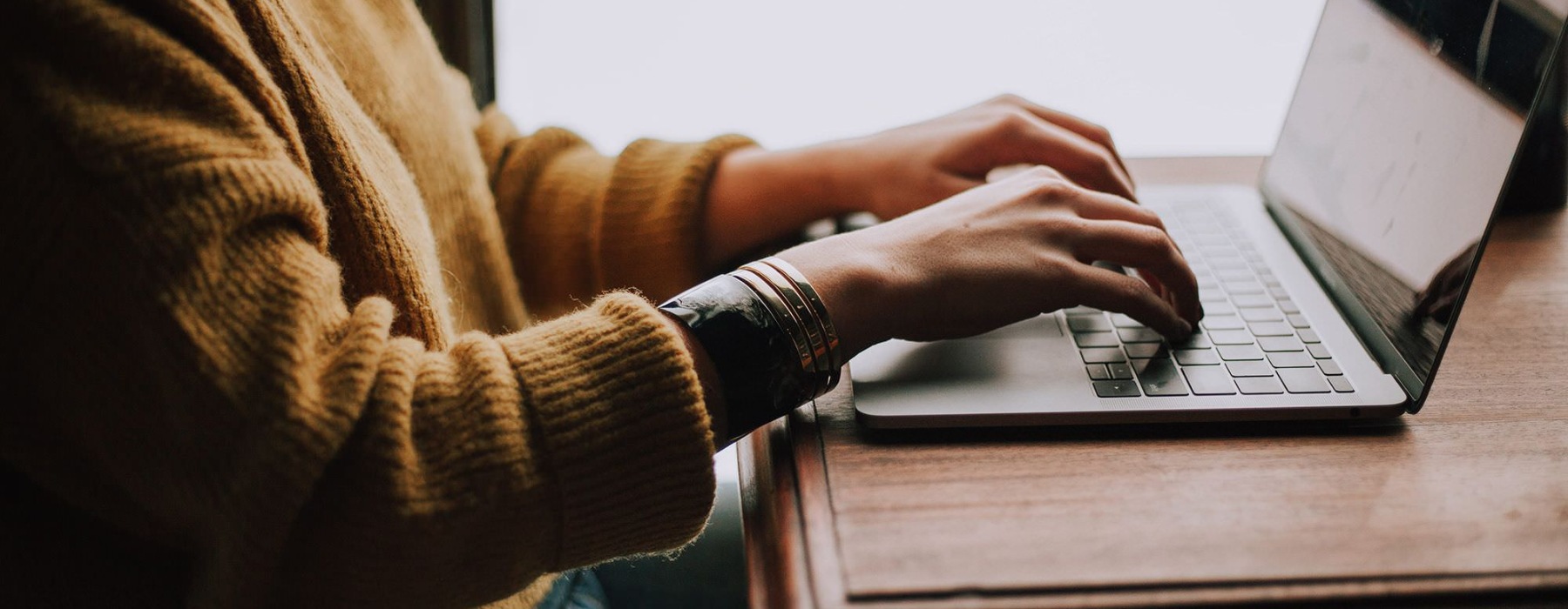 woman typing on a laptop